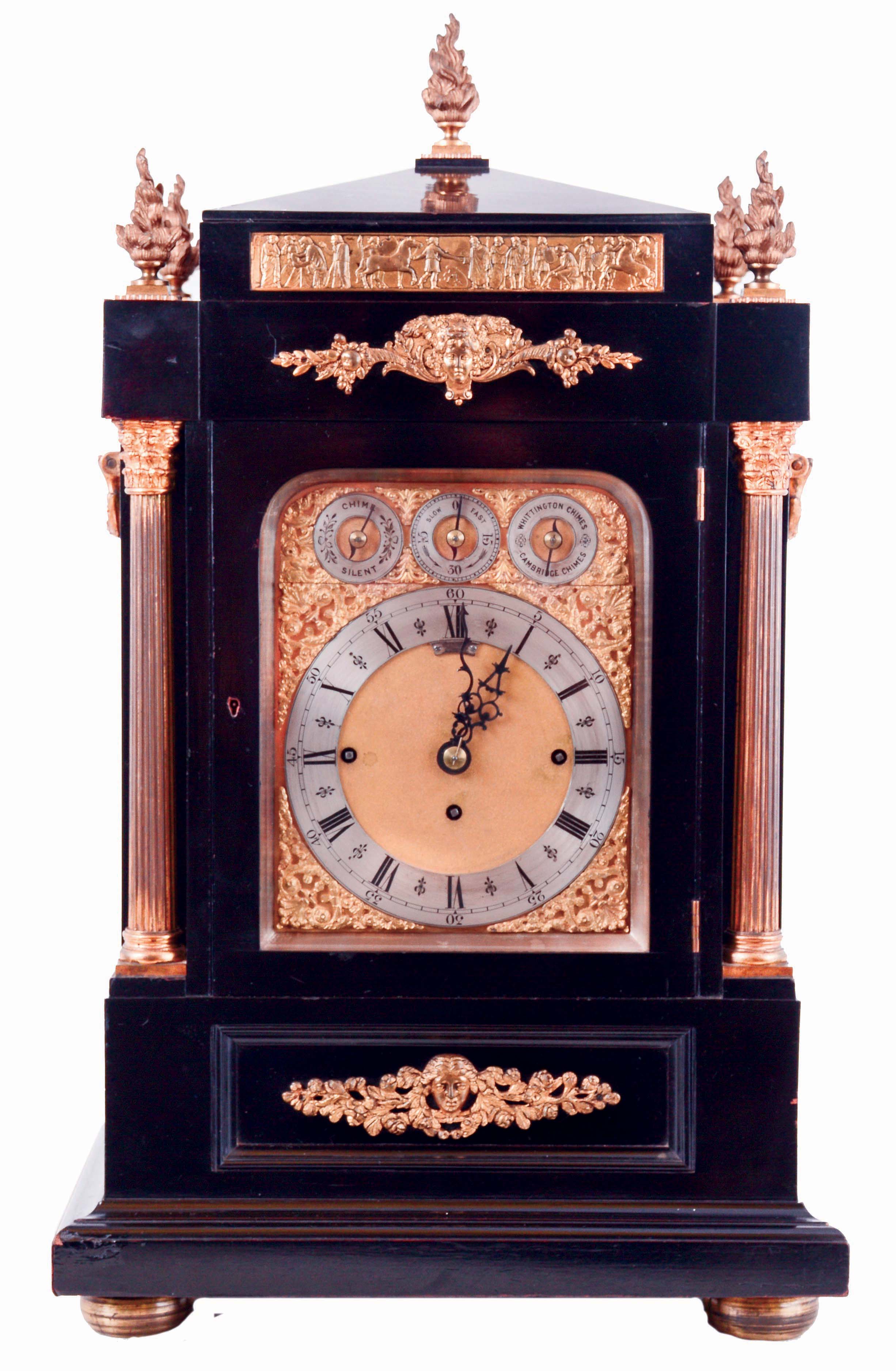 James Dimmick, Cowes, England, a monumental bracket clock, ebonized mahogany case, mounted with detailed gilt bronze ornaments in the neoclassical style, fluted Corinthian columns flanking the gilt composite dial, with Roman numeral silvered chapter ring and pierced, blued steel hands, and also with chime/ silent, regulation, and chime selection at top, case sides with gilt, pierced frets and ornamental carrying handles, pyramidal top with 5 flame finials, all resting on a molded base with compressed ball feet, massive quarter striking, 8 days, 3 train fusee movement, playing Cambridge and Whittington chimes on 8 bells, and counting the hours on a large gong, c1880 — Antique Clocks Price Guide