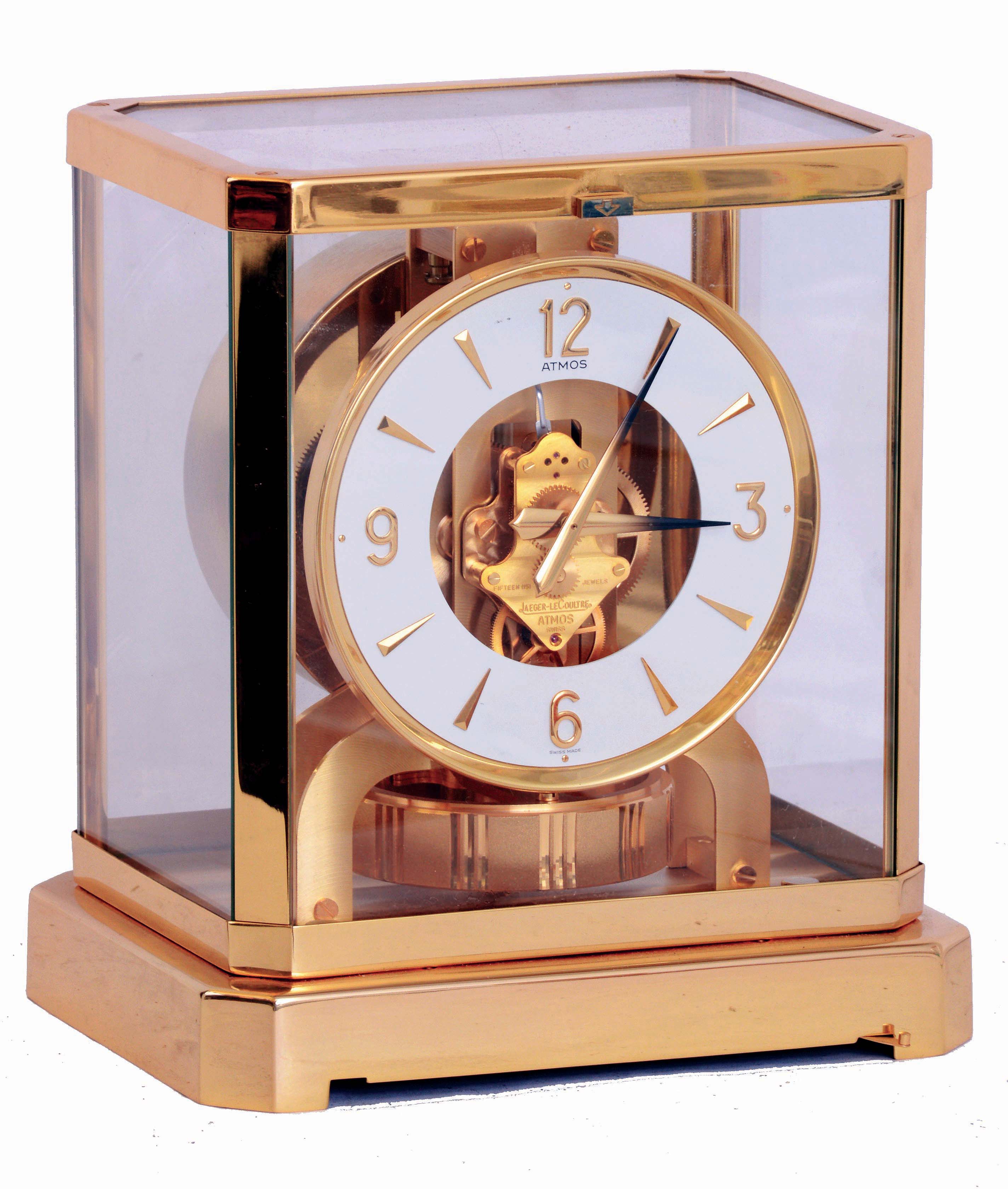 Jaeger- LeCoultre, Switzerland Atmos clock, cal.528-8, gilt, rectilinear glazed case, the base with cotes de Geneve decoration, Arabic numeral and arrow marker white painted dial, gilt hands with black tips, 15 jewel gilt movement, serial #555799, c1975 — Antique Clocks Price Guide