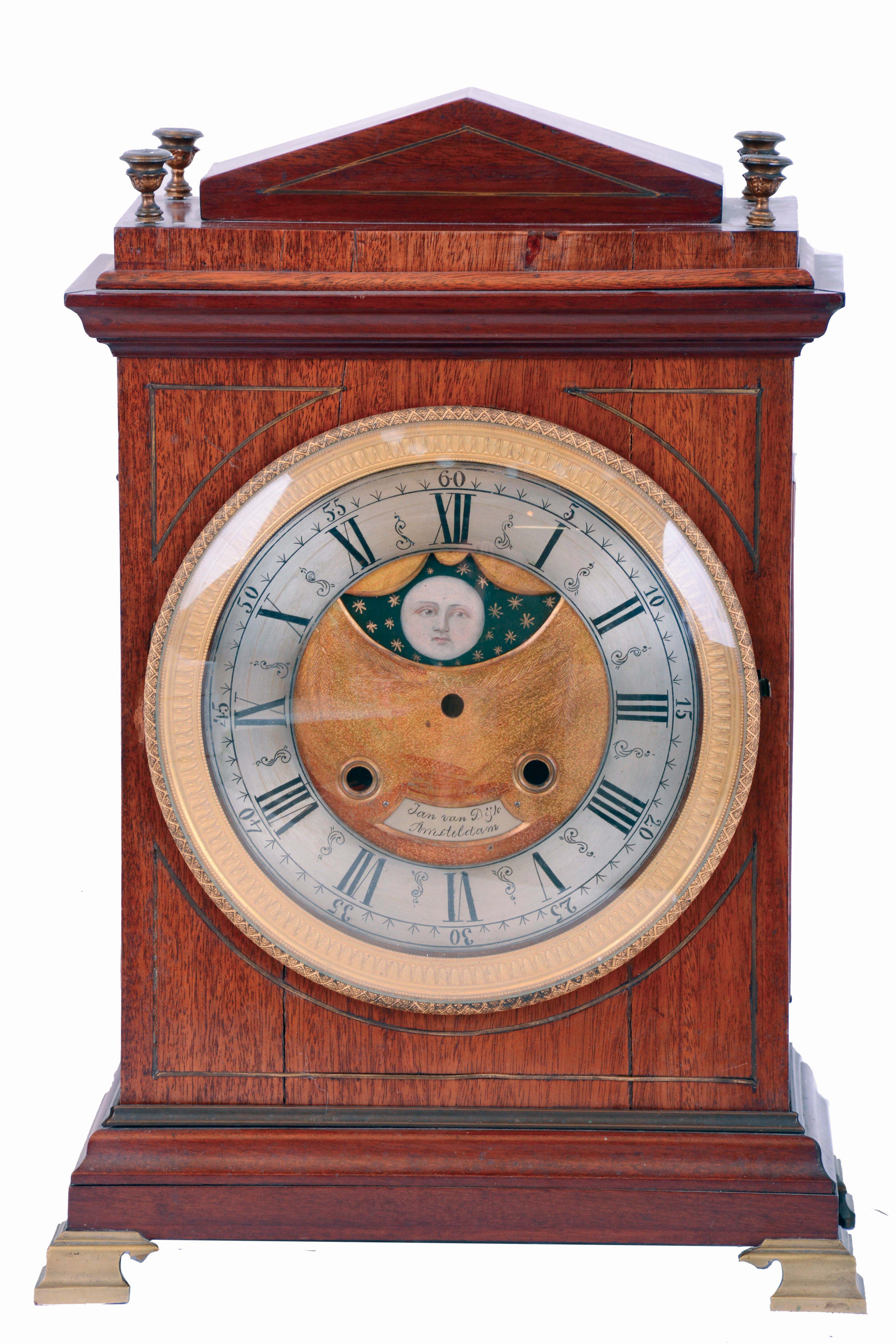 European bracket clock, mahogany and mahogany veneer oak case in the Regency style, gilt brass bracket feet, brass stringing and molding, engine turned gilt bezel with Roman numeral silvered dial, the matted, gilt center with silvered plaque signed "Jan Van Dijk Amsterdam", and also with painted moon phase disc, 15 day rectangular brass, time and strike movement with verge escapement, five turned baluster pillars, pierced steel warning and locking levers, movement early 18th century, case early 19th century — Antique Clocks Price Guide