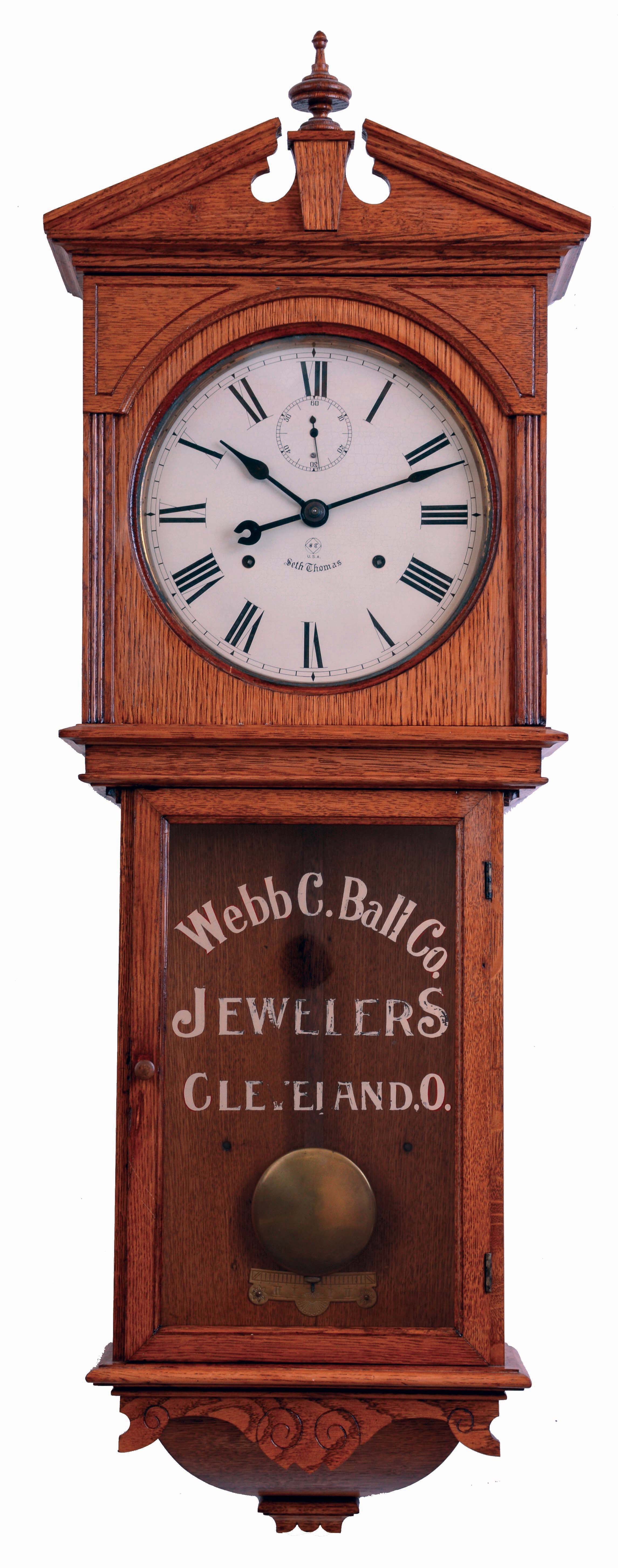 Seth Thomas Clock Co., Thomaston, Conn., "Umbria", 15 day, double wind spring driven brass movement wall timepiece in oak case with gilt lettered advertising tablet of "Webb C. Ball Co., / Jewelers / Cleveland, O", c1894 — Antique Clocks Price Guide