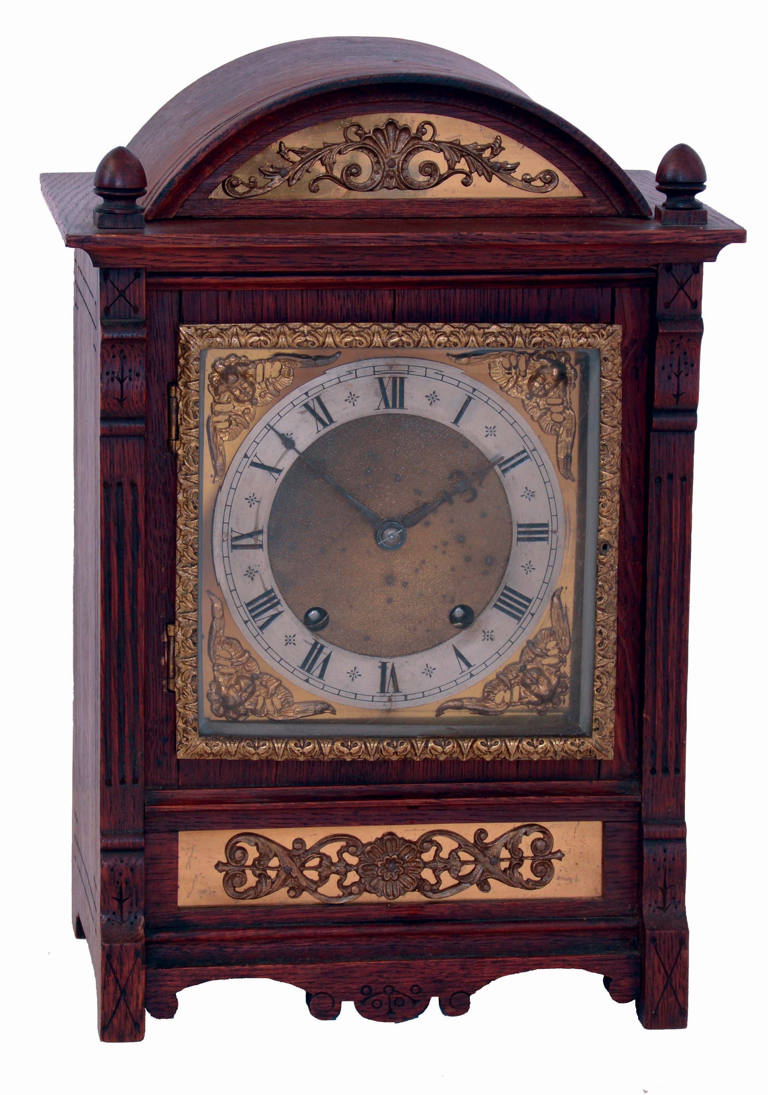 German oak unsigned, 8 days, two-train striking bracket clock in arch topped wood case with decorative brass panels, c1900 — Antique Clocks Price Guide