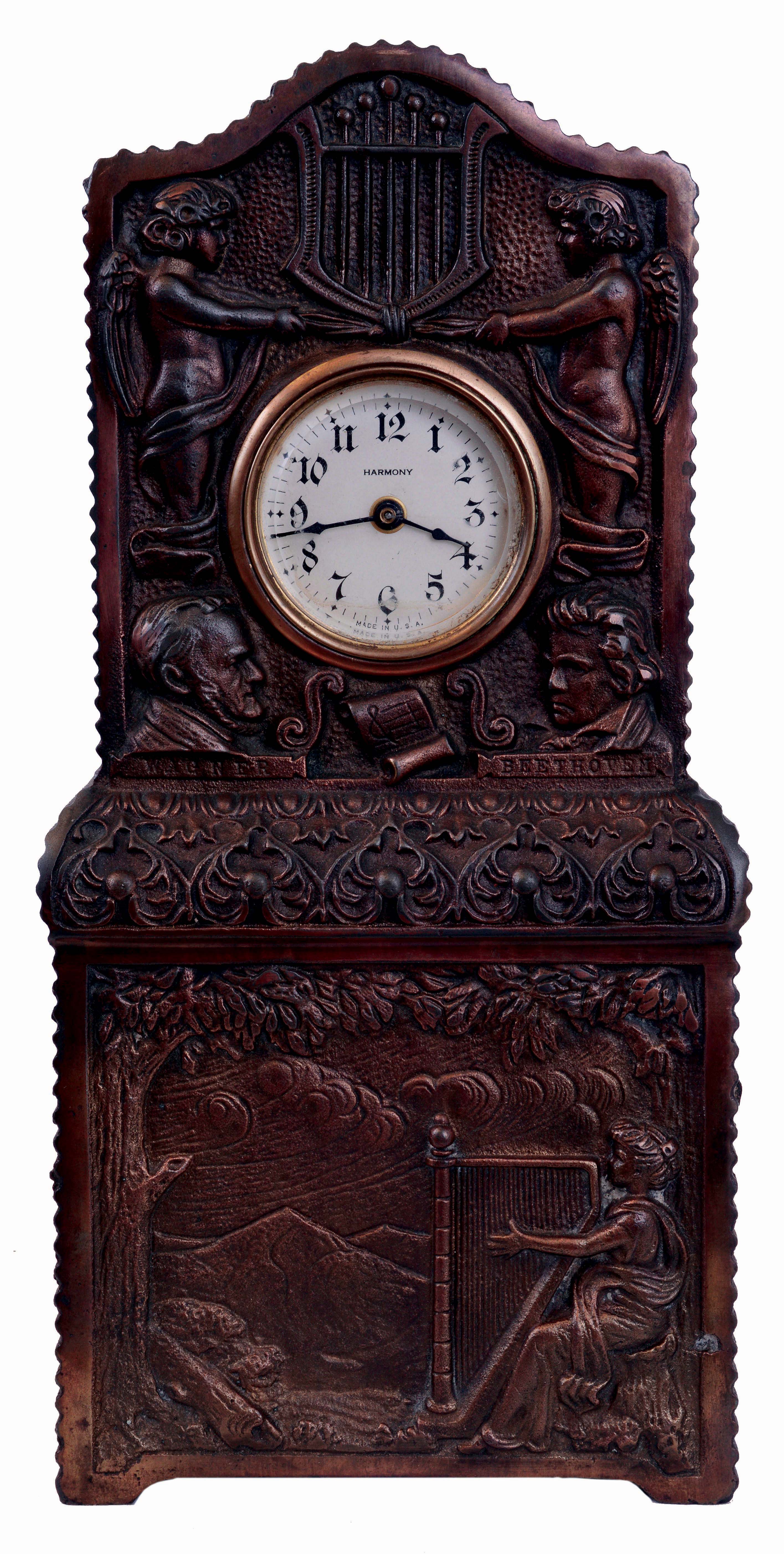 Ansonia Clock Co., New York, NY, "Harmony" novelty clock with two tune music box in base, bronze finished cast iron case, the base with a harpist in a landscape, the upper section with Arabic numeral dial marked "Harmony", with flanking putti and lyre, also with busts of Wagner and Beethoven, 30 hours, timepiece movement, c1900 — Antique Clocks Price Guide