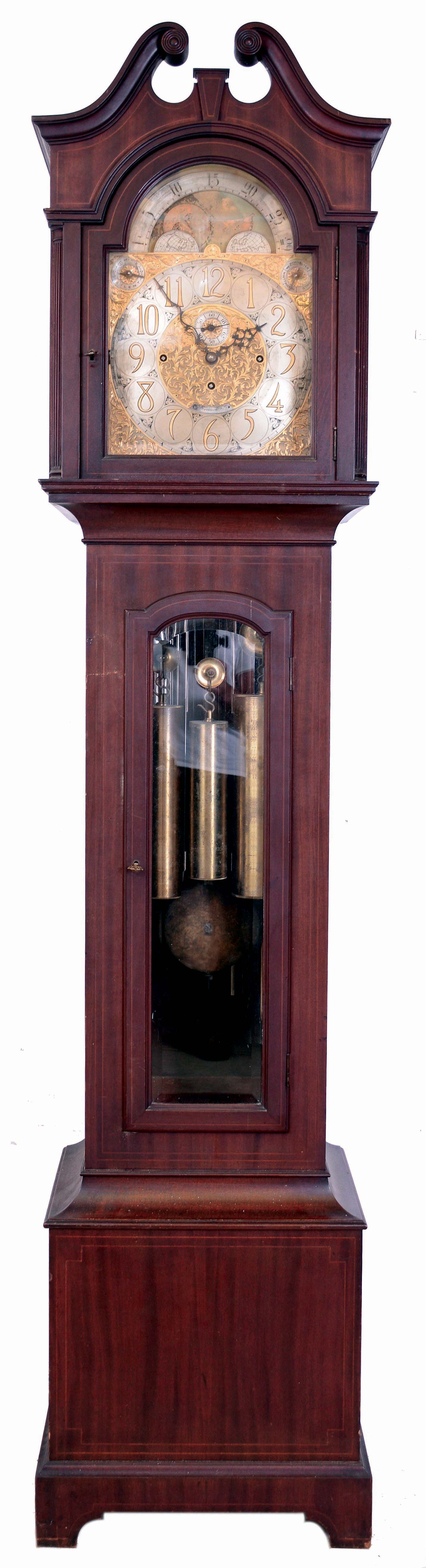 Tiffany & Co., New York, 9 tube hall clock, 8 days, time, strike and chime, three weight driven movement by Elliot, London, playing three tunes (Westminster, Whittington and St. Michael's on tubes signed with patent date Dec. 4th 1906) in mahogany, string inlaid case on bracket base, broken arch hood with turned rosettes, beveled glass door in trunk and hood. The brass arched dial has a silvered chapter ring with applied brass numerals, surrounded by a finely engraved foliate mask, turned spandrels and dial center, moon phase, selection for chime or silent and tune, and second's bit, c1915 — Antique Clocks Price Guide