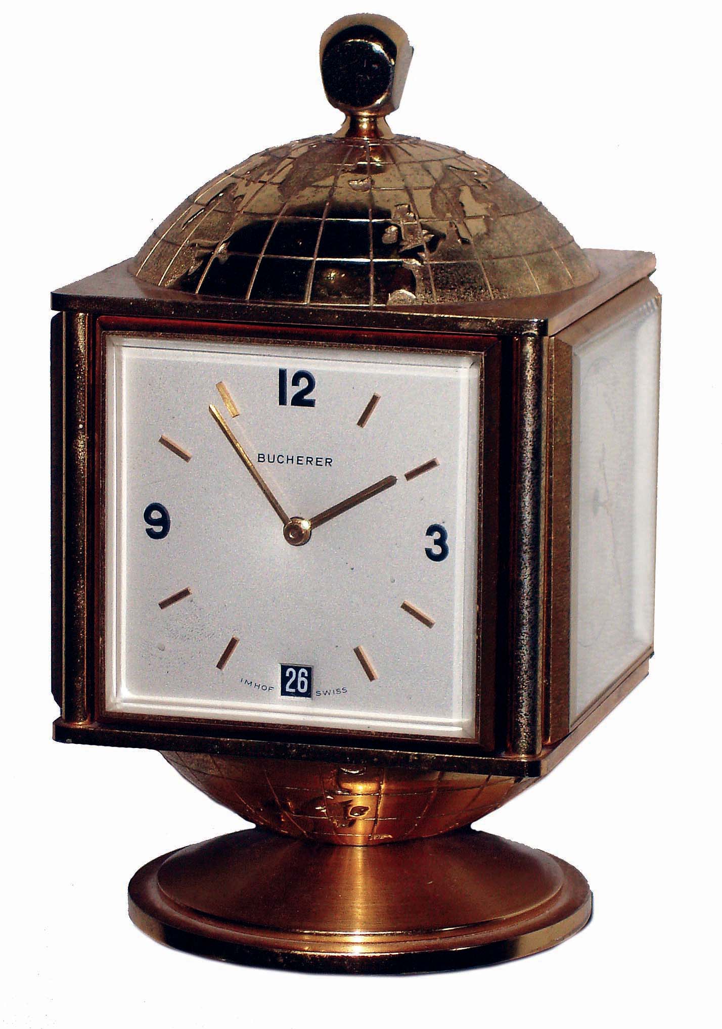 Bucherer, Swiss, 8 days, 15 jewel globe-top brass and beveled glass clock with calendar and weather station, rotating base, c1970 — Antique Clocks Price Guide