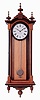 E. Howard & Co., Boston, Mass., "No. 59-8 Regulator" reissue. Walnut case with ebonized moldings, turned and carved finials, maple weight baffle, ebonized wooden bezel with Roman numeral white painted dial, blued steel moon hands, nickel pendulum with silver painted wooden rod, 8 days weight driven timepiece movement, with Howard paperwork, serial #0059, August, 1976