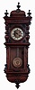 Germany, smaller walnut cased spring "Vienna" regulator, double door style, with embossed dial center bearing a cherubs face below 12, and the embossed pendulum with a similar large central cherubs face. 8 days, time and gong strike, c1900