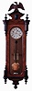 Lenzkirch, Germany 2-weight "Vienna Regulator" in a walnut veneer case with four half finials mounted toward the center of the door, and full finials top and bottom, and with original top trim and spread eagle, serial #650,560, This clock retailed by M. Tiefel, Mainz, Germany, as noted on dial, c1884.