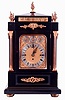 James Dimmick, Cowes, England, a monumental bracket clock, ebonized mahogany case, mounted with detailed gilt bronze ornaments in the neoclassical style, fluted Corinthian columns flanking the gilt composite dial, with Roman numeral silvered chapter ring and pierced, blued steel hands, and also with chime/ silent, regulation, and chime selection at top, case sides with gilt, pierced frets and ornamental carrying handles, pyramidal top with 5 flame finials, all resting on a molded base with compressed ball feet, massive quarter striking, 8 days, 3 train fusee movement, playing Cambridge and Whittington chimes on 8 bells, and counting the hours on a large gong, c1880