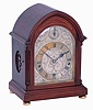 Clocks- 2 (Two) Bracket Chiming: (1) German oak, 8 days, time, strike and Westminster chime round top bracket clock, with subsidiary indicators for chime/silent and fast/slow adjustment, c1910 (2) J.J. Elliott, for Tiffany & Co., New York, mahogany, 8 days, balance wheel bracket clock with Westminster chimes on coiled gongs, c1910