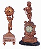 Clocks- 2 (Two): Both desk clocks, one a New Haven on a marbled base supporting a gilt spelter case and surmounted by a putto, enamel dial and 30 hour timepiece, the other French, a gilt putto holding the spherical case above his head, and standing on a marble base with gilt ornament, 8 days, timepiece with lever platform, both c1900