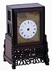China, bracket clock, camphor wood case with glazed panels, resting on a pierced and carved base, Roman numeral white enamel dial mounted to a brass plate, brass time and strike fusee movement with verge escapement, and engraved back plate