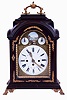 Austria, bracket clock, ebonized case with molded break arch top, molded base, cast brass feet and carrying handle, sheet brass dial with mock pendulum, gilt spandrels, Roman numeral white enamel dial, the arch with controls for the striking, and with landscape painting on enamel, pierced and engraved brass hands, case with glazed sides, and Helios mask frets, three train, quarter striking movement with verge escapement, strike trains with going barrels, time train with fusee, c1800