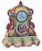 England, Strasburg Ware clock, with French movement, colorful earthenware case, enamel scene with figures in a landscape below the dial, Arabic numeral white enamel dial with putto and floral festoon, the case resting on its original Strasburg Ware base, 8 days, time and strike movement, c1920