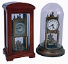 Clocks- 2 (Two): Early anniversary clocks, one in a wooden case, back plate marked "BHA", the other on a brass base with dome, marked "Gustav Becker", both with disc pendulums, c1920
