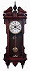 Waterbury Clock Co., Waterbury, Conn., "Eton" wall hanging clock in a walnut case with a spring driven, 8 days, time and strike movement, c1906.