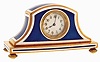 Desk clock, gold plated Napoleon hat form case, blue guilloche enamel panels with white enamel borders, Arabic numeral white guilloche enamel dial, 30 hours key wind and set movement with cylinder escapement, c1900
