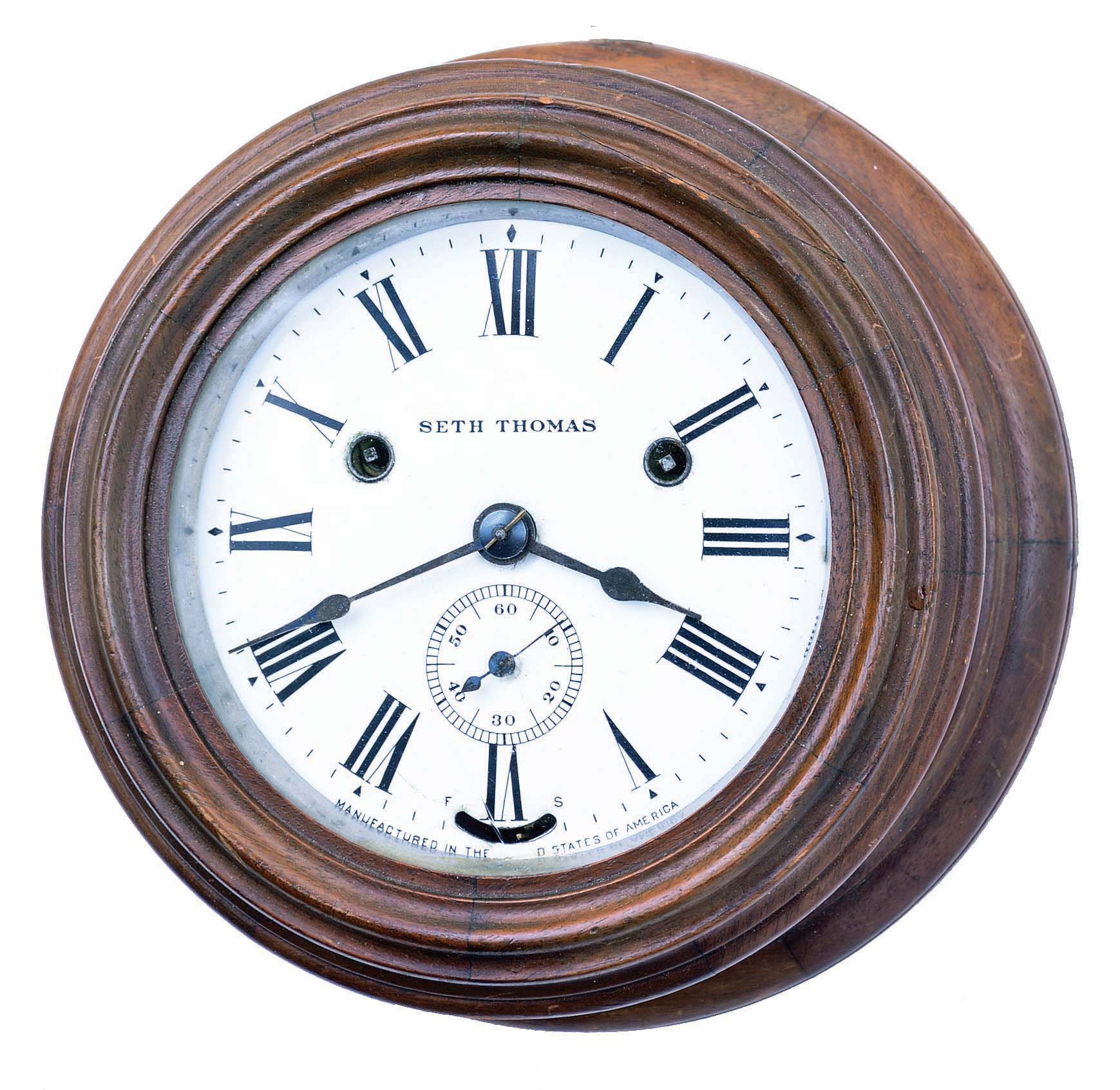 Seth Thomas Clock Co., Thomaston, Conn., "Wardroom" wall clock with a one-day spring driven time and ship's bell strike movement deeply turned in a mahogany case, — Antique Clocks Price Guide
