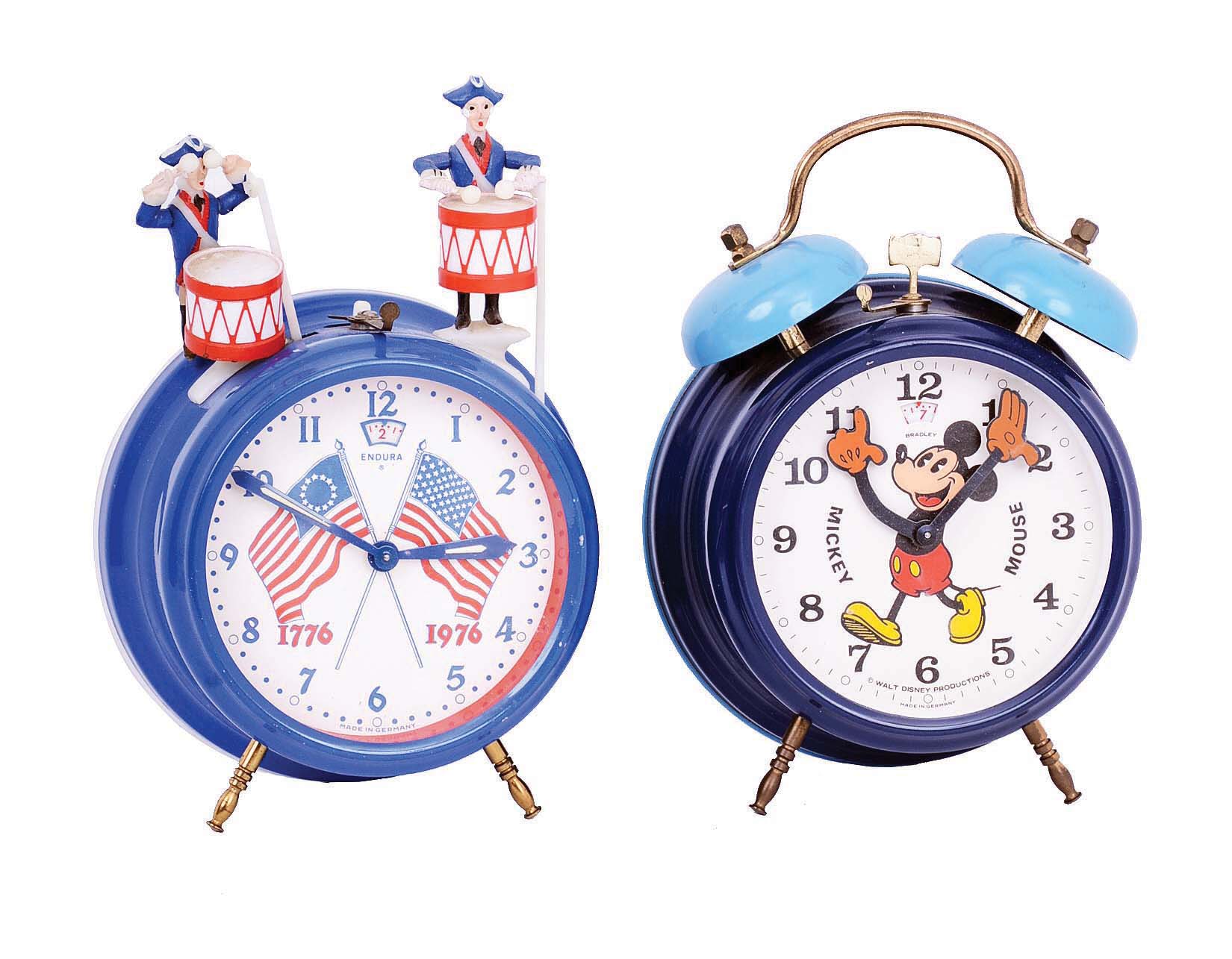 Clocks- 3 (Three): E. Ingraham & Co., Bristol, Conn., "Treasure", (erroneously, but commonly called "Treasure Island") , 8 day, mahogany, time and strike, spring-driven banjo clock, c1934; two German painted metal alarm clocks - Mickey Mouse by Bradley and American Bicentennial by Endura, 3.5" dials, c1976 — Antique Clocks Price Guide