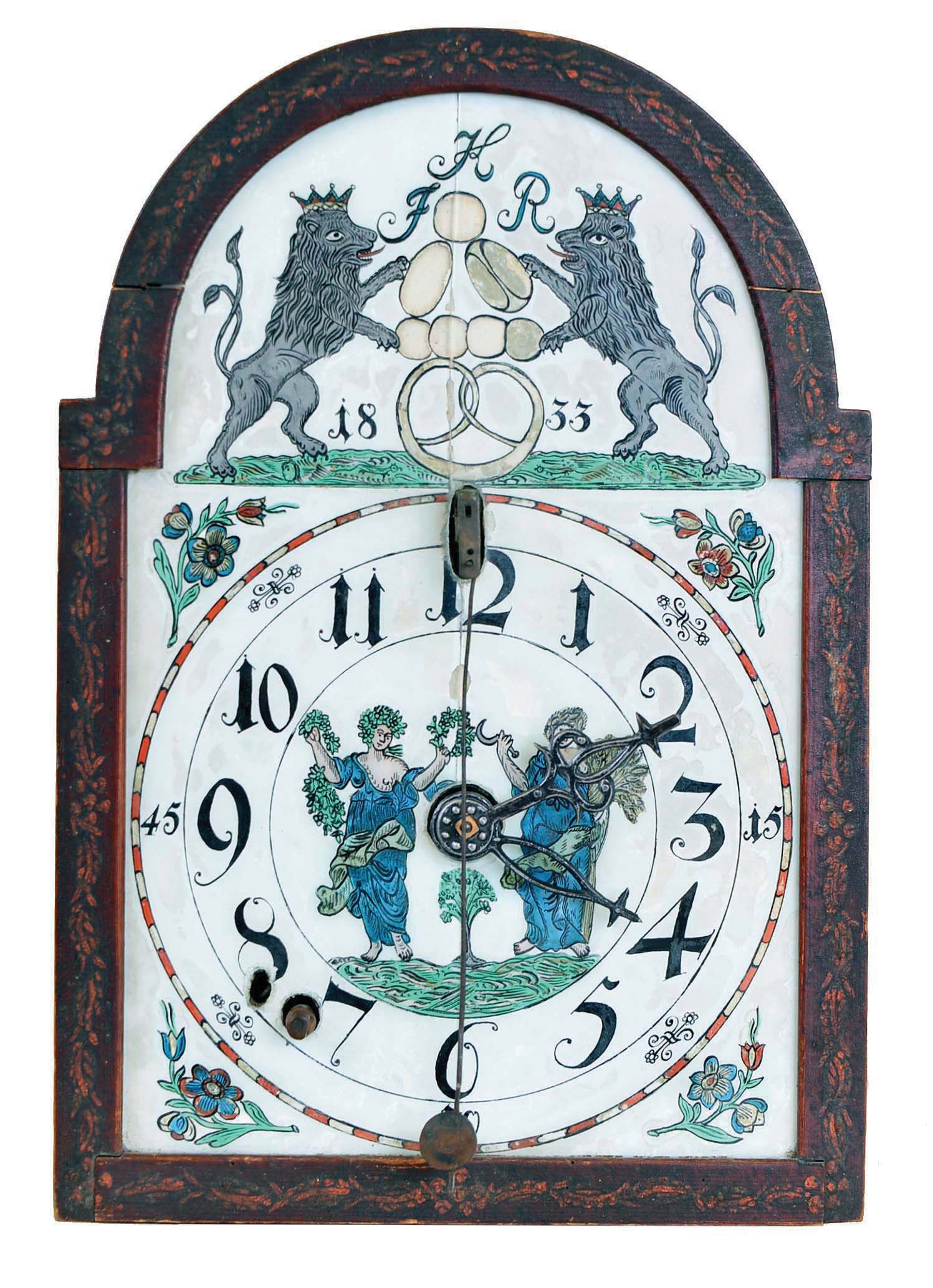 German, multi-tune musical dial clock, with 9 glass bells, and reverse painted glass dial with family crest in arch (HFR) and dated 1833, 1 day wooden works, [3-weight], time, strike on one bell, and music actuated by 5in (12.6cm) wide pin drum, front pivoted cows tail pendulum. — Antique Clocks Price Guide