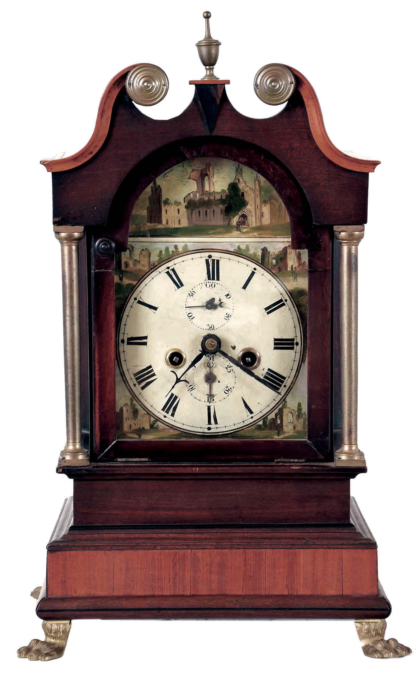 Bracket clock, mahogany and mahogany veneer case, the stepped base with ebony inlays, and resting on cast paw feet, supporting a tall clock style bonnet with brass columns, ebony plinth block and boxwood broken arch and top molding, painted sheet iron dial with Roman numeral chapter ring, faux date display, and with paintings of ruins in the arch and spandrels, steel hands, 8 day time and strike fusee movement, brass pendulum, 19th century — Antique Clocks Price Guide