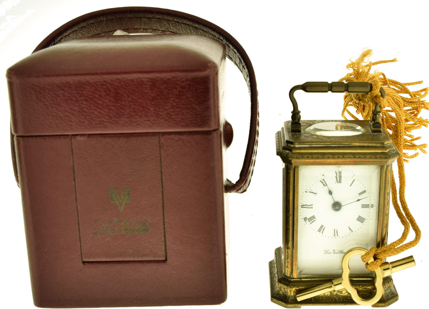 Matthew Norman, Switzerland, "La Vallee" miniature carriage clock, glazed, engraved brass case, Roman numeral white enamel dial, blued steel hands, 11 jewel, 8 day timepiece movement with lever platform, with leather covered travel case — Antique Clocks Price Guide