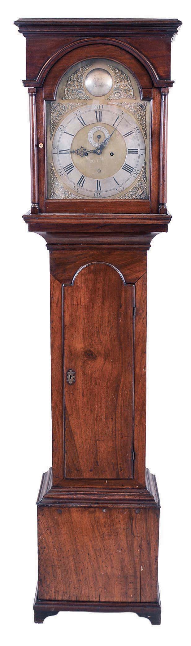Isaac Brokaw, Elizabethtown, NJ, tall case clock, 8 day, time and bell strike, weight driven movement in a flat top mahogany case with tombstone trunk door. The brass dial has a silvered chapter ring, brass spandrels, circular calendar aperture at 6, second's bit and signature boss. — Antique Clocks Price Guide