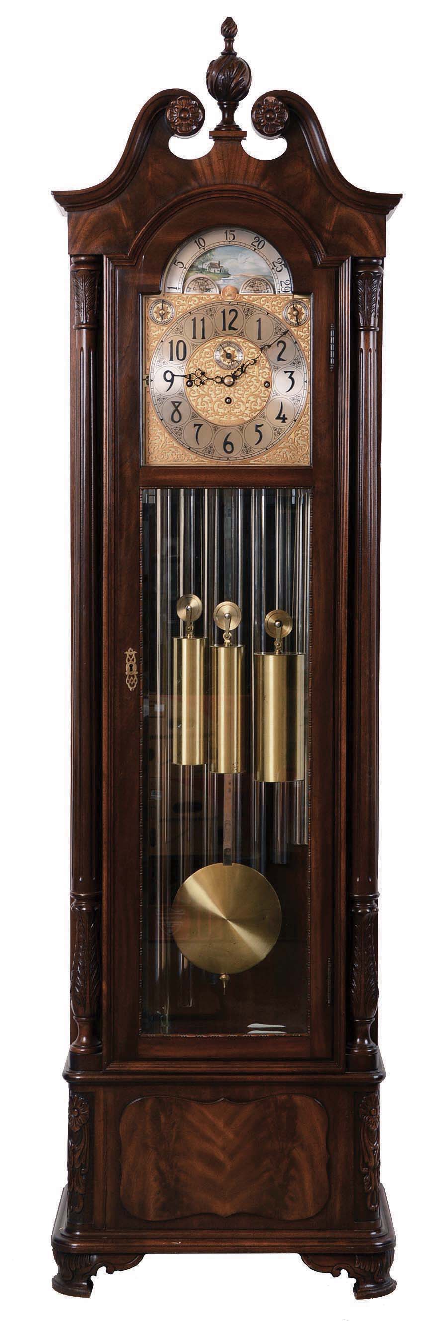Herschede Clock Co., Cincinnati, Ohio, "Haverford No. 294" hall clock, 8 days, time, strike & chime, three brass weight driven movement playing three tunes on 9 tubes, Westminster, Wittington, Canterbury in a mahogany case with fluted columns with Acanthus carved capitals and bases, cutout base with raised burl panel, bracket feet and beveled glass sides and door, The broken arch top has carved floral rosettes and a finely carved center finial. The brass dial silvered chapter ring and tune and strike / silent selectors, applied cast brass and engraved dial center and spandrels and moon phase, serial no. 628255 — Antique Clocks Price Guide