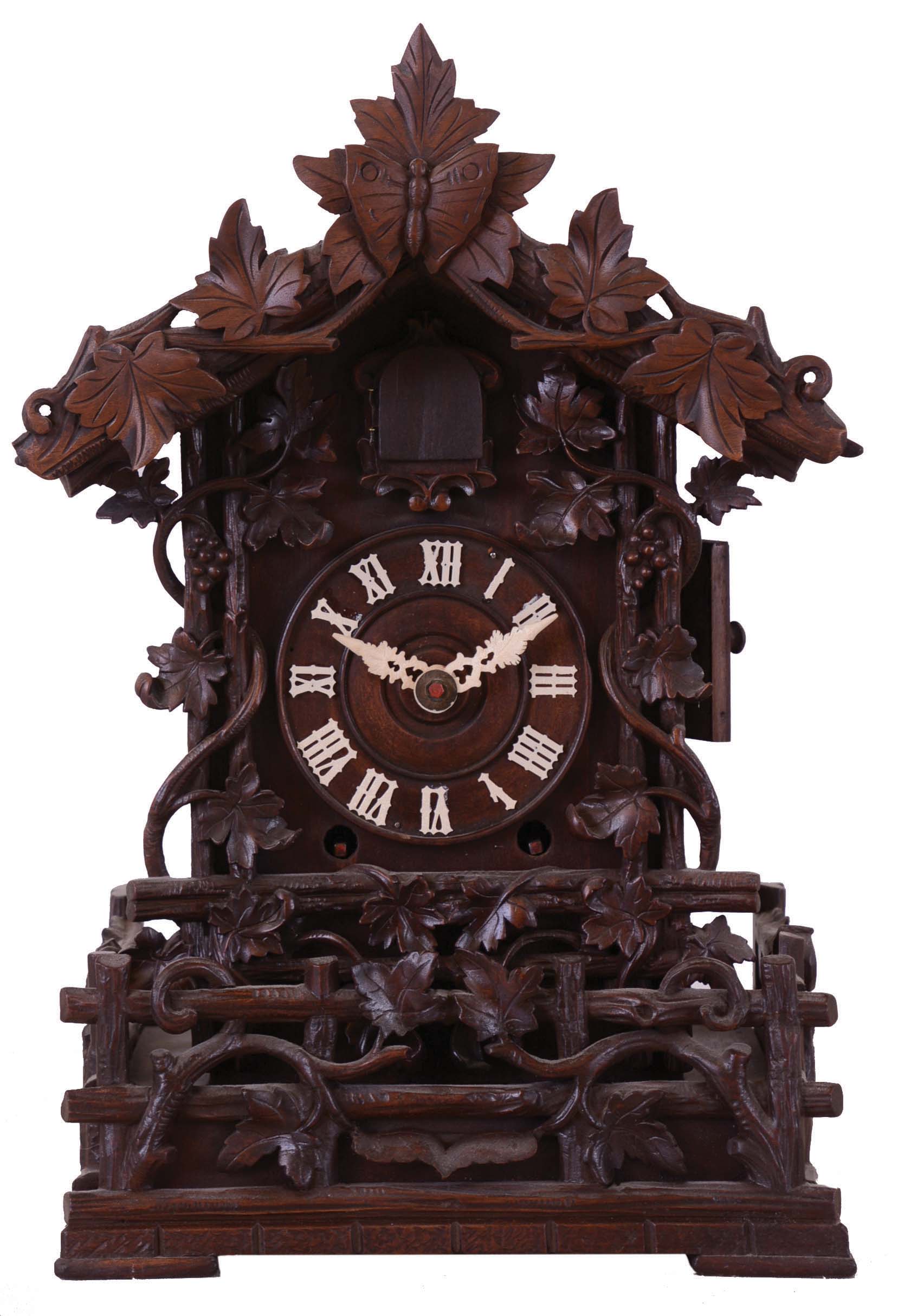 Johann Baptiste Beha, Germany, Black Forest small shelf cuckoo. 8 day wood plate spring-driven movement with double fusees in an elaborately carved case with foliate, vine and fence decoratoins. The wooden dial has Roman numerals and bone hands. This model "No. 509" is illustrated in Justin Miller's book, Appendix A which is the Beha catalogue reprinted. — Antique Clocks Price Guide