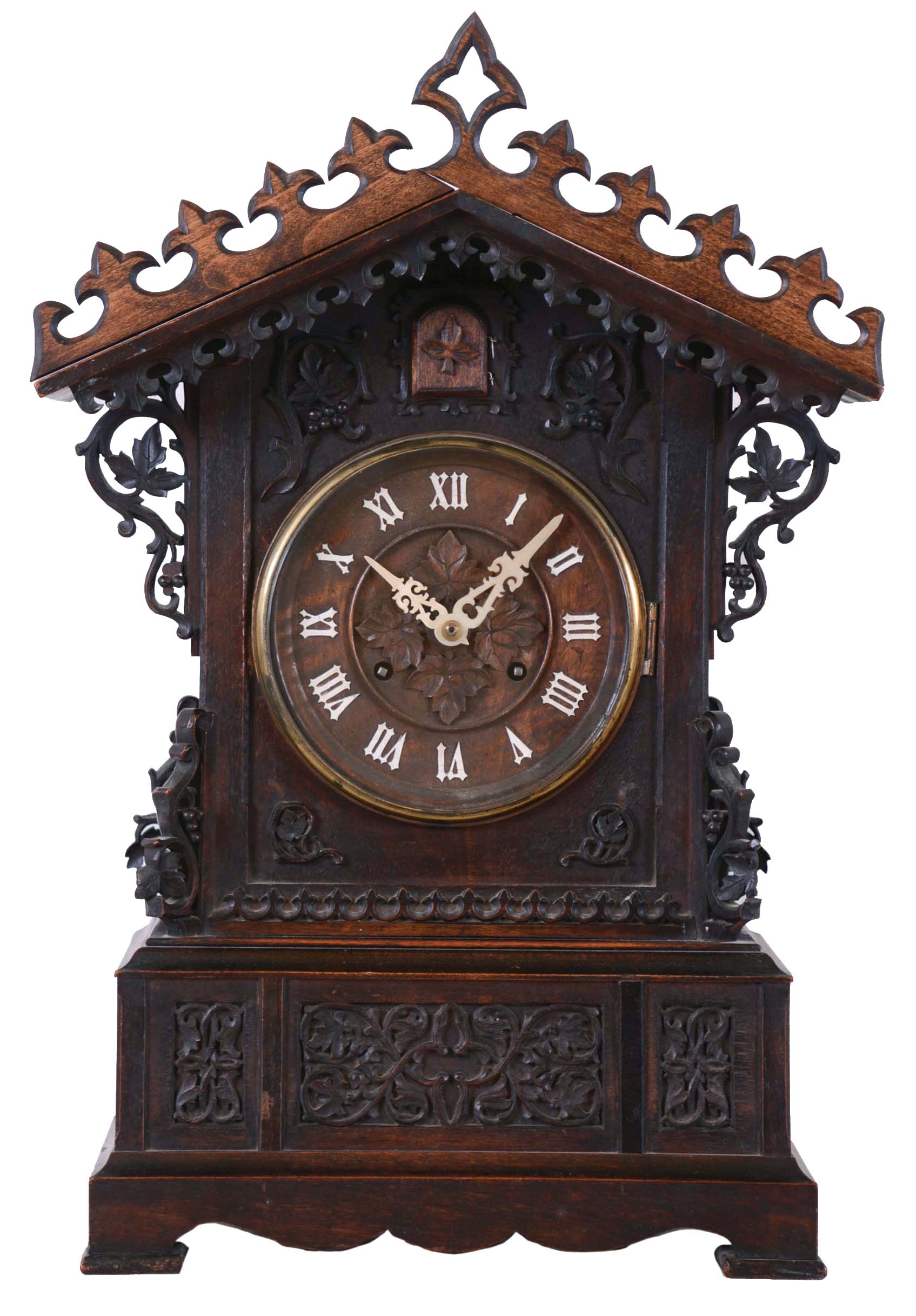 Johann Baptiste Beha, Germany, for Camerer, Kuss & Co., shelf cuckoo, architectural walnut case with inset panels containing carved trailing vine and leaf ornament, carved buttress corners, and repeating carved fleur de lys trim above and below gable, wooden dial with applied Roman numerals, with protective glass set in a brass bezel, pierced bone hands, full bodied wooden bird, large 8 day, time and strike fusee movement with brass plates, brass pendulum, case back with Camerer, Kuss & Co. label — Antique Clocks Price Guide