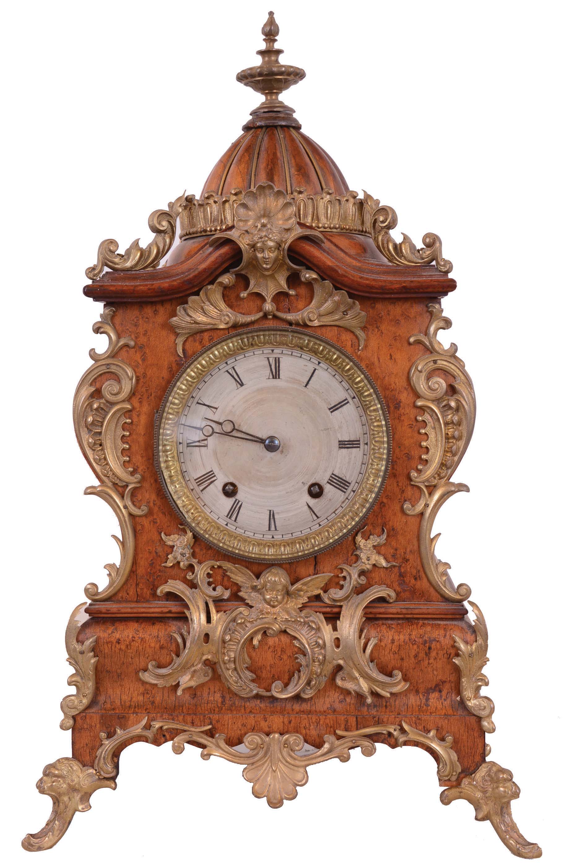 Lenzkirch Clock Co., Germany. 8 day time & strike mantel clock with dome topped wood case, fancy metal feet and applied metal decoration. Serial number 824081. — Antique Clocks Price Guide