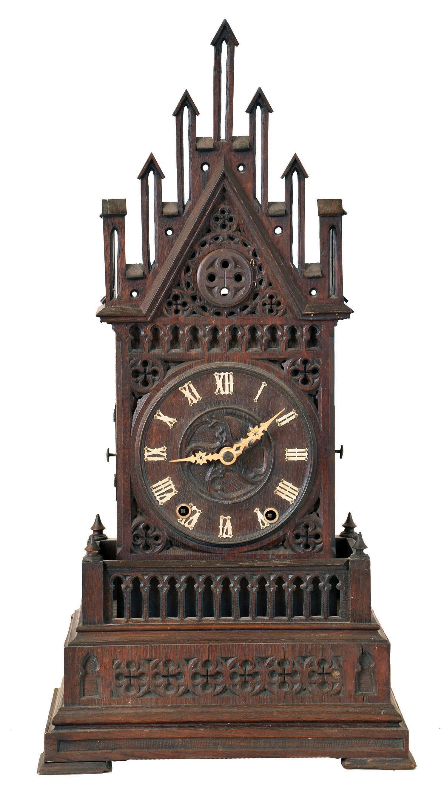 Shelf Cuckoo, in the Gothic style, oak architectural case with crenellated parapet and gable, the front and sides with pierced and carved blind fretwork with various foils, carved wooden dial with applied Roman numerals, carved bone hands, 50 hour time and strike, spring driven movement with beech plates and brass wheels — Antique Clocks Price Guide