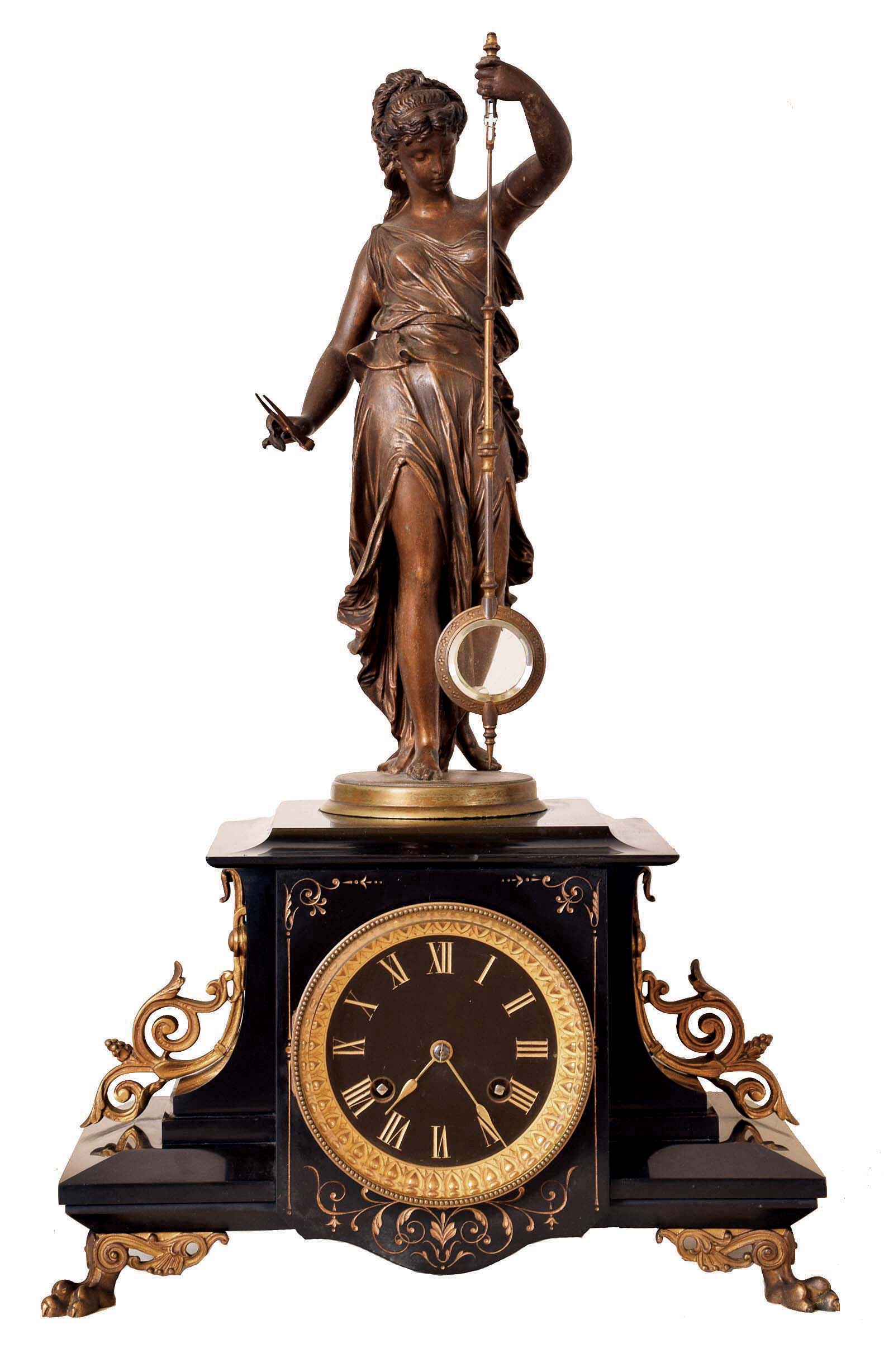Guilmet, France, mystery clock, black slate case with incised line decoration, foliate side ornaments, and paw feet, surmounted by a patinated female figure, her left hand held aloft, and suspending the pendulum, impulsed through the nearly imperceptible movement of the gilt base on which the she stands, gilt Roman numeral black slate dial, gilt spade hands, 8 days time and strike movement with crank and stirrup escapement, back plate with Guilmets mark and numbered 1958 — Antique Clocks Price Guide