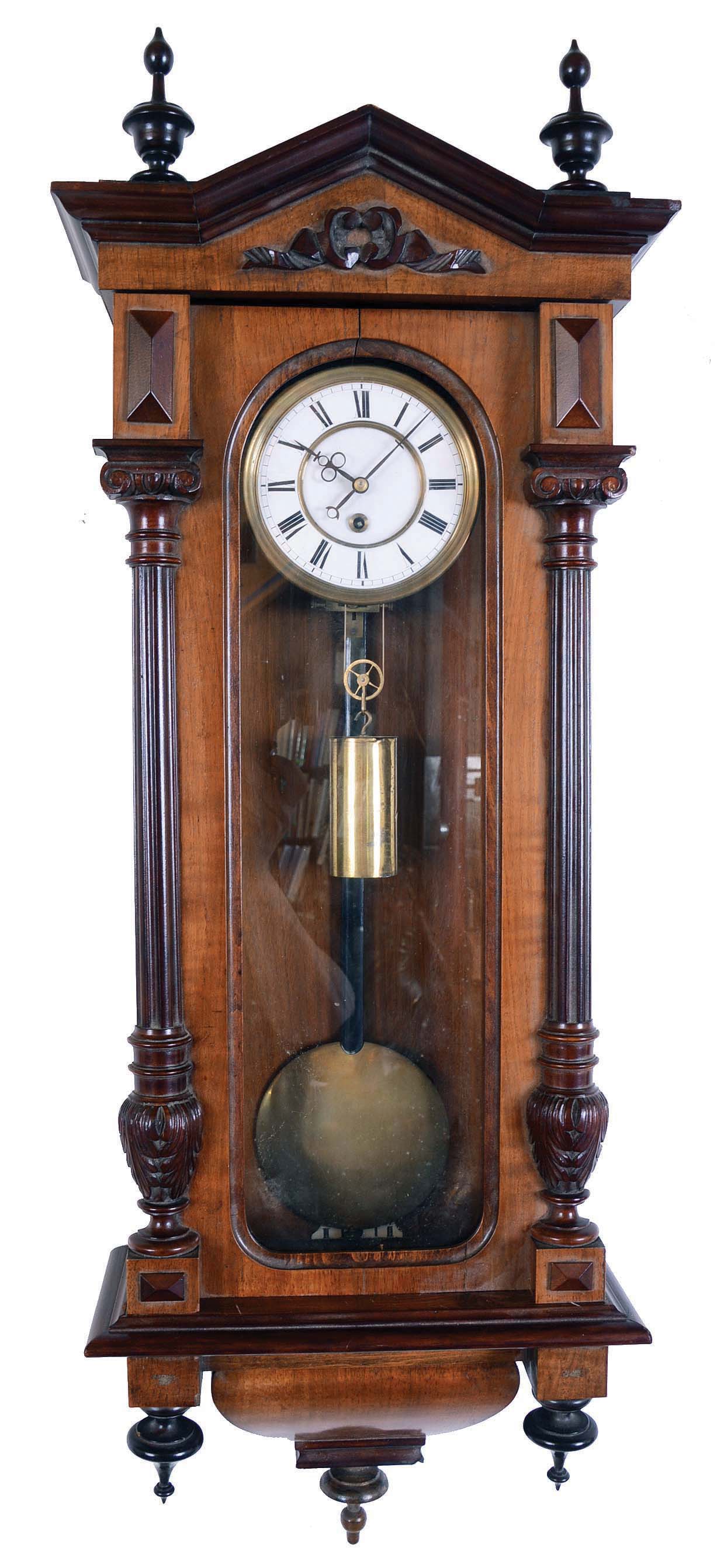Germany, unsigned Vienna regulator, 8 days, time only, weight driven movement in a two tone carved walnut case with carved appliques and two part white enamel dial. — Antique Clocks Price Guide