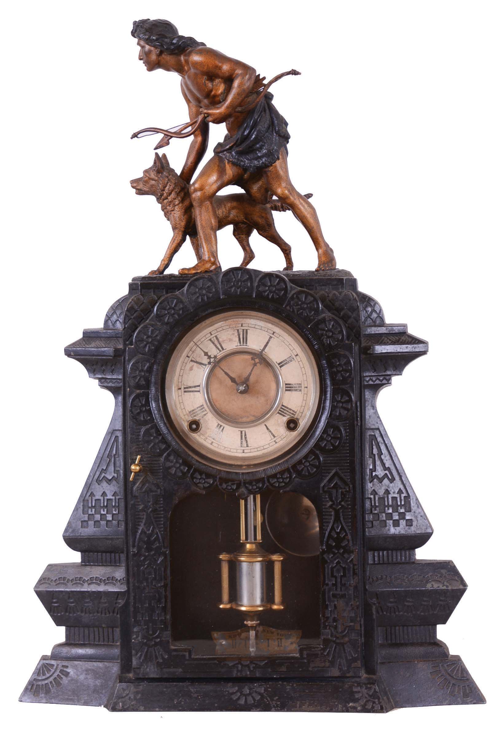 F. Kroeber Clock Co., New York, "Indian Hunter V.P.", 8 day, time and strike spring brass movement metal front mantel clock. This a Nicholas Muller case No. 181 and is stamped on the case. The statue is copied from the original by John Quincy Adams Ward, a famous American sculptor, which was completed in 1886 and stands in Central Park, New York. Herman Muller, son of Nicholas and brother-in-law of Kroeber, was granted a patent for this case design in 1880, seven years after his father's death. — Antique Clocks Price Guide