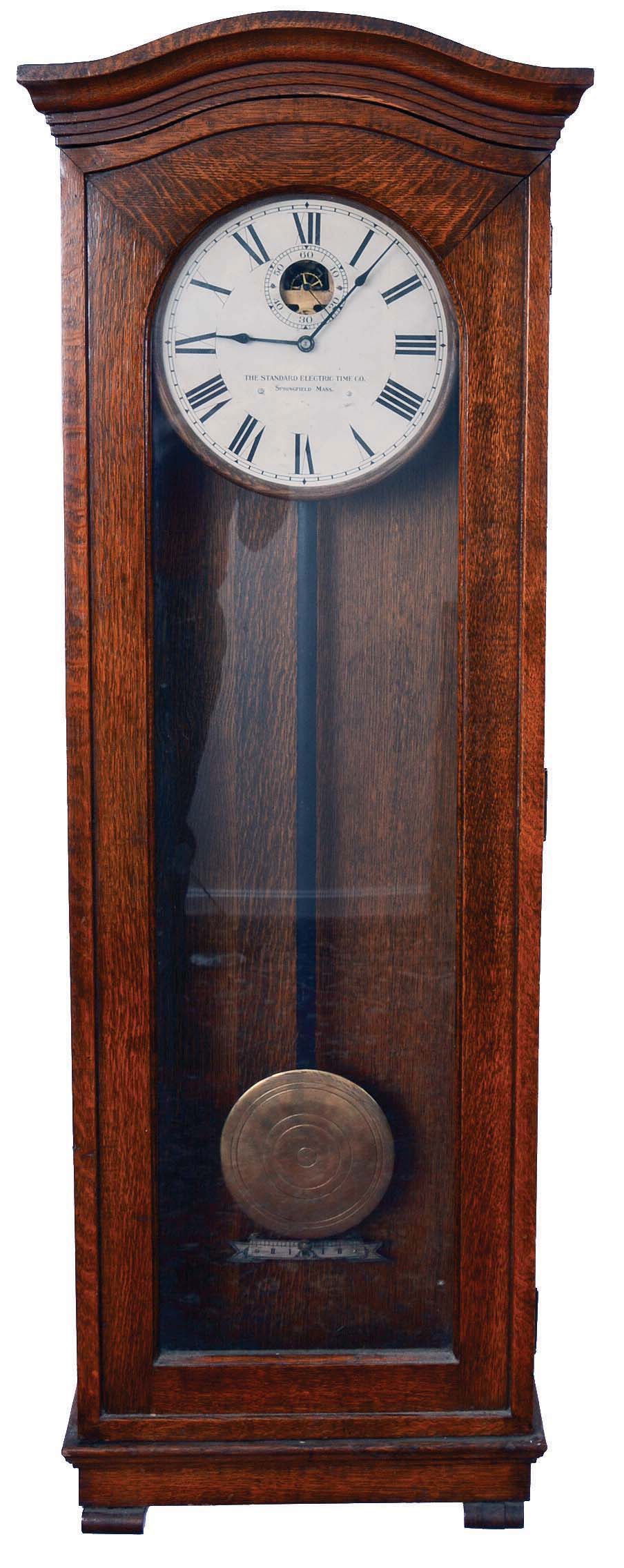 Standard Electric Time Co., Springfield, Mass., "Master Clock", time only, electrical driven movement in an oak case with a brass pendulum bob with concentric circles and painted metal dial — Antique Clocks Price Guide