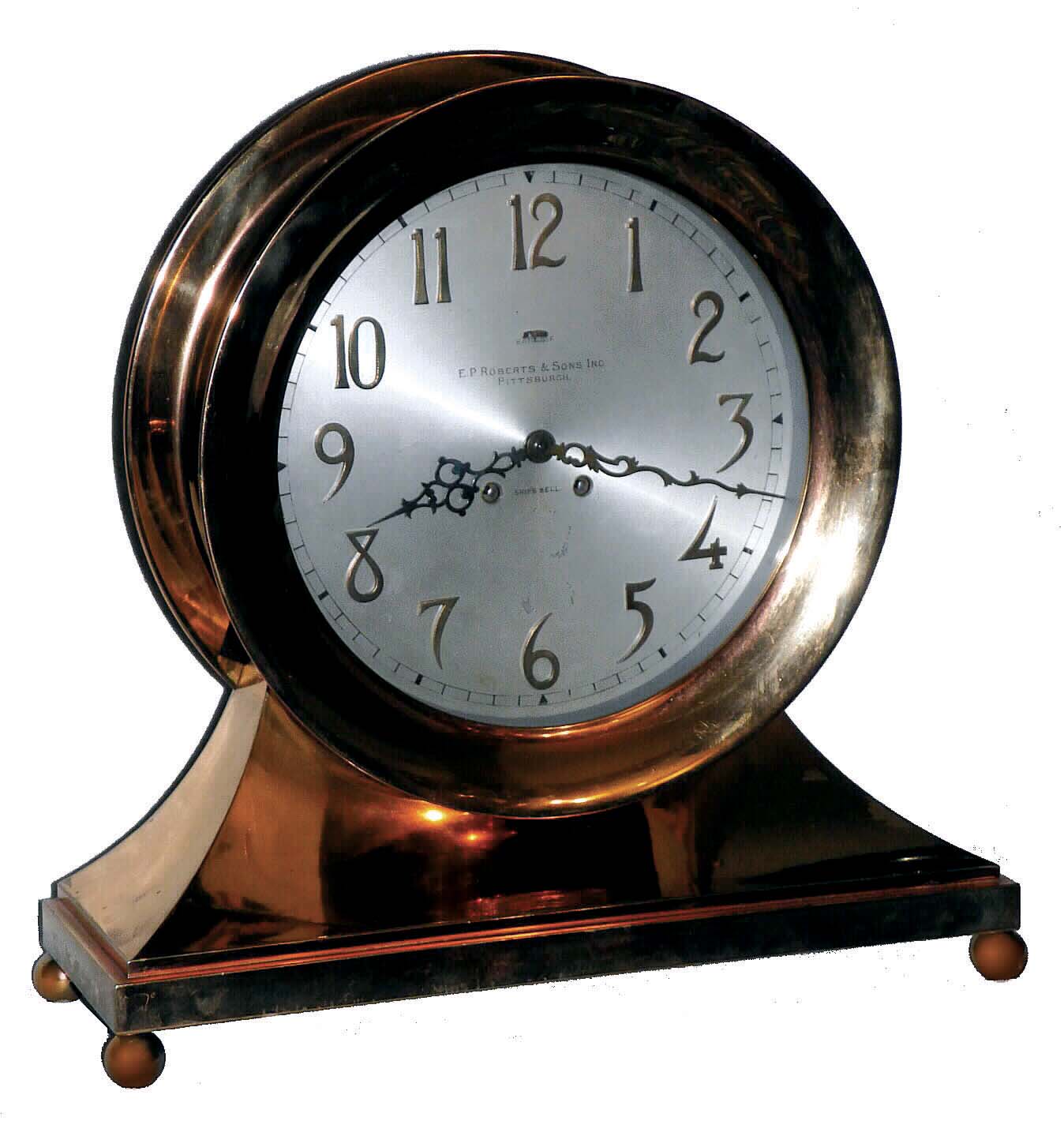 Chelsea Clock Co., Boston, Mass., Mass, a base and ball special "Commodore" ship's bell clock with ten inch dial {24.5cm}, in a red brass case with hinged bezel & button latch, retailed by E. P. Roberts & Sons, Pittsburgh as indicated on dial. — Antique Clocks Price Guide