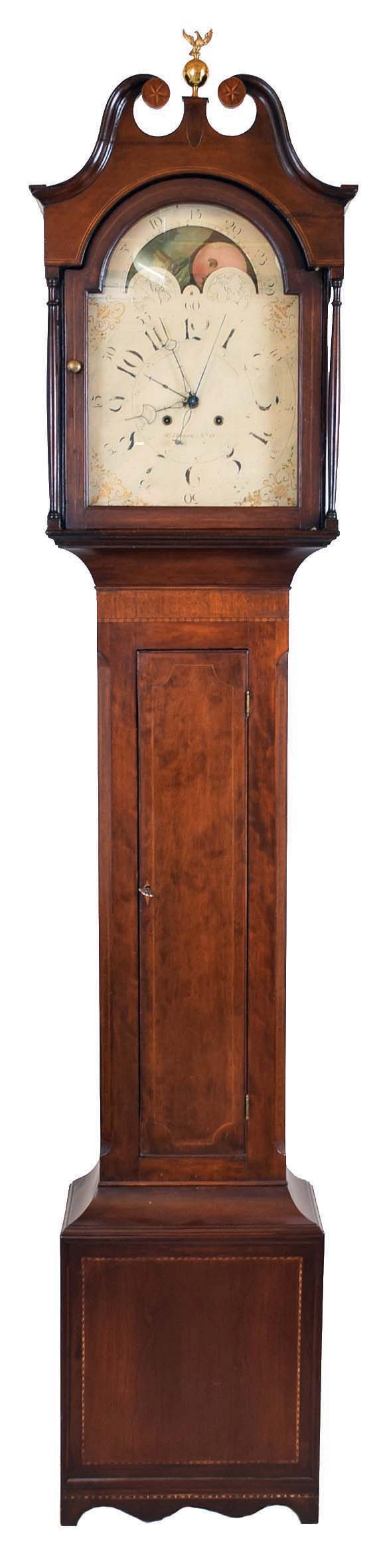 William Herwick (Sr.) , Greensburg, Penn., "No. 15" tall case clock, 8 day, time and strike, weight driven movement in a cherry case with broken arch top, center brass eagle finial, star inlaid rosettes and four full columns flanking hood, string inlaid doors and cross hatching on trunk and cutout bracket base with inlaid panel. The painted metal dial with maker's signature has date calendar, sweep seconds and moon phase. The dial's false plate is signed "PATTON & JONES PHILA". — Antique Clocks Price Guide