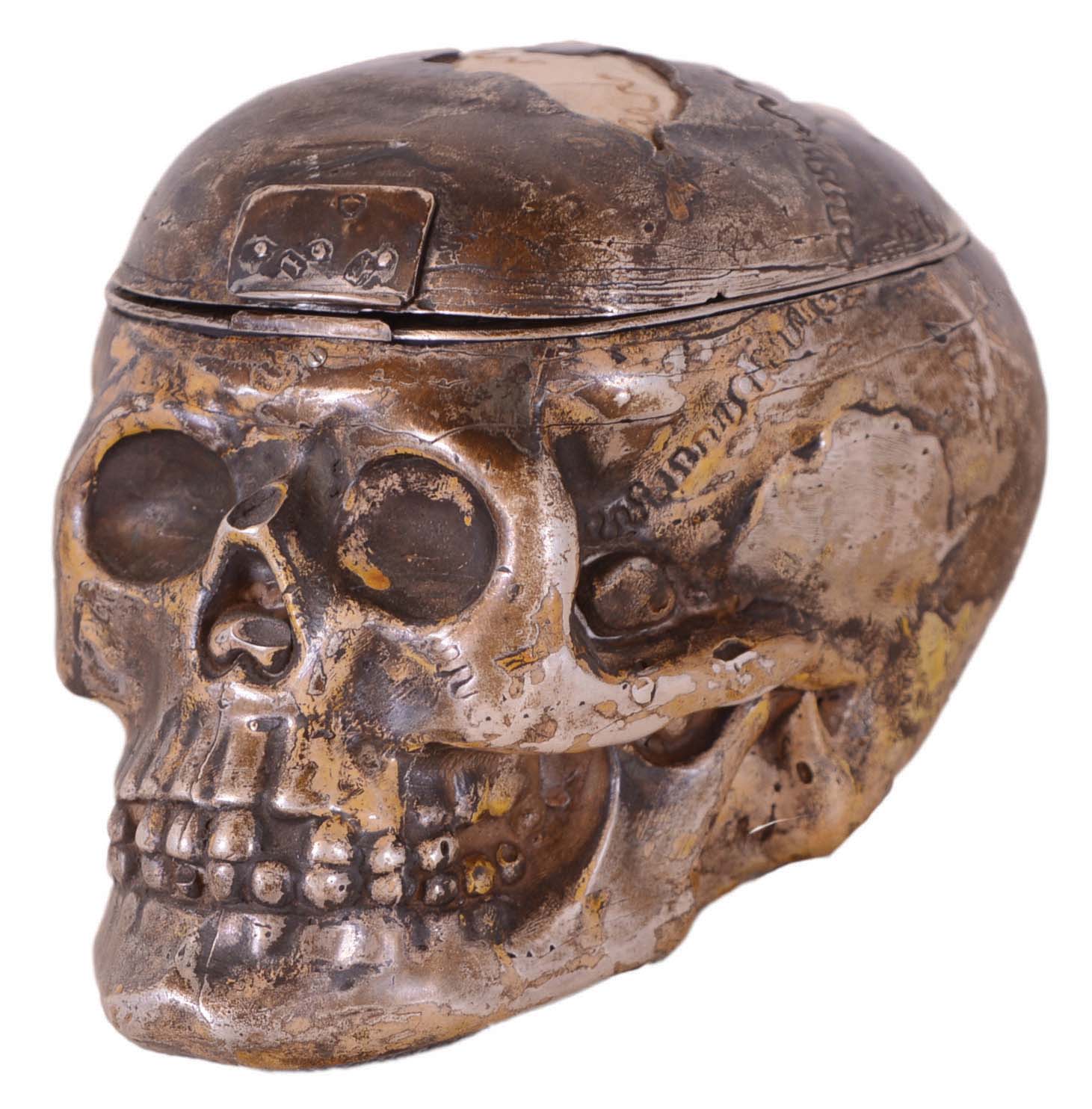 Desk clock, skull form case made of carved bone and silver, the hinged top concealing a key wound lever fusee watch movement with Roman numeral gold dial, set in an engraved silver surround — Antique Clocks Price Guide