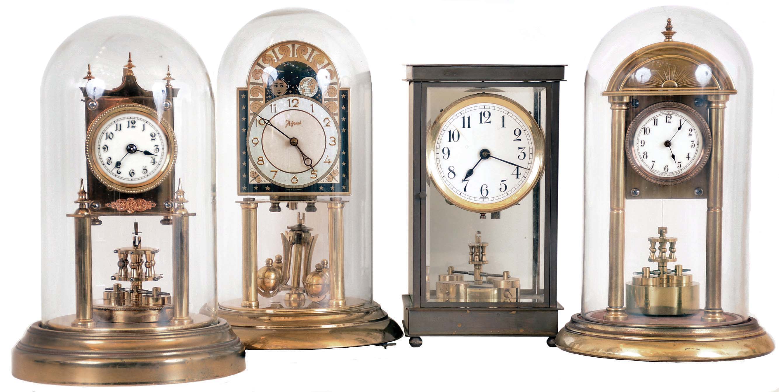 Clocks- 4 (Four) German "Anniversary" or 400-day clocks: Three are earlier with disk pendulums, including one by Becker and one by Anniversary. Three have round glass domes; One is the 4-glass crystal regulator style. The modern 4-ball model, with a John Wannamaker on the dial, has a functional moon phase indicator above the dial. 20th century — Antique Clocks Price Guide