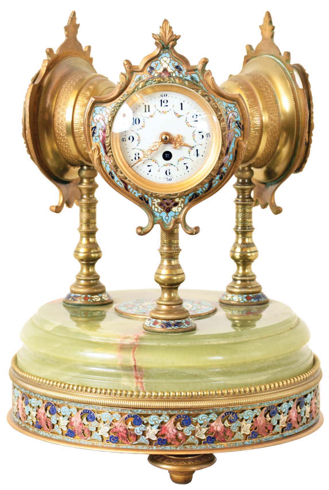 France, desk or table clock with weather station, the round, molded, green onyx base on ornamental gilt feet, and with wide, champleve enamel trim, and central champleve plaque, supporting three ornamental, turned columns surmounted by decorative cases with champleve enamel shields, one containing an 8 day timepiece with Arabic numeral white enamel dial and gilt, Louis XV hands, the second with centigrade and fahrenheit thermometers on a white enamel dial, and the last with barometer, also with white enamel dial — Antique Clocks Price Guide