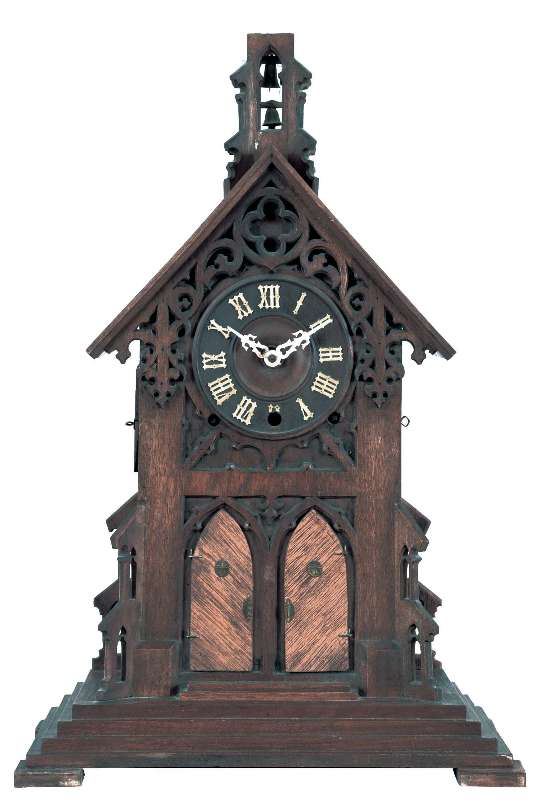 Gordian Hettich Sohn, Germany, "Bell Ringers", walnut, architectural, Gothic style case with stepped base, buttressed corners, and gable with pierced, carved tracery with quatrefoil at top, and finished with a belfry, the front with two lancet arch doors concealing the figures which reveal themselves and "ring" the bells at the quarters, Roman numeral wooden dial, pierced hands, 50 hour, three train brass movement striking the quarters on two bells, and counting the hours on the larger bell, the back plate marked "G.H.S" — Antique Clocks Price Guide