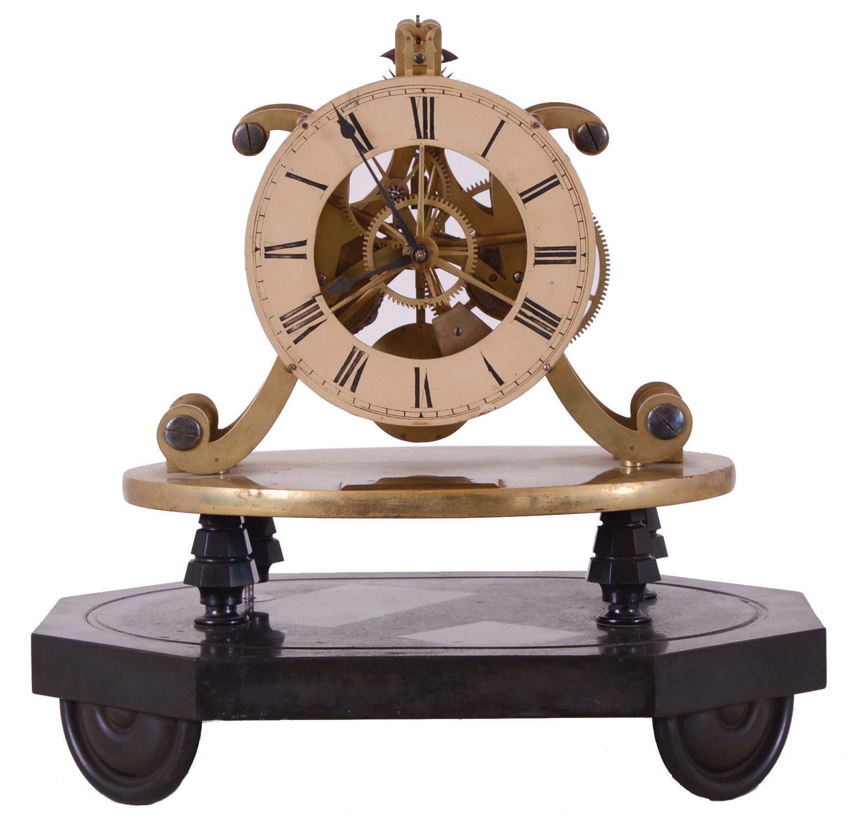 England, after Strutt & Wigston, skeleton clock with epicyclic gearing, 8 day timepiece movement with fusee, well executed five spoke gearing, and nicely finished pierced brass plates, the epicyclic gearing visible between the front plate and the Roman numeral painted dial, blued steel spade hands, the movement mounted to an oval brass plate, the plate with plaque engraved "Wm. Strutt Esqr. Invt", the plate supported on four tapered columns, all on an oval, black slate base with half round turned feet — Antique Clocks Price Guide
