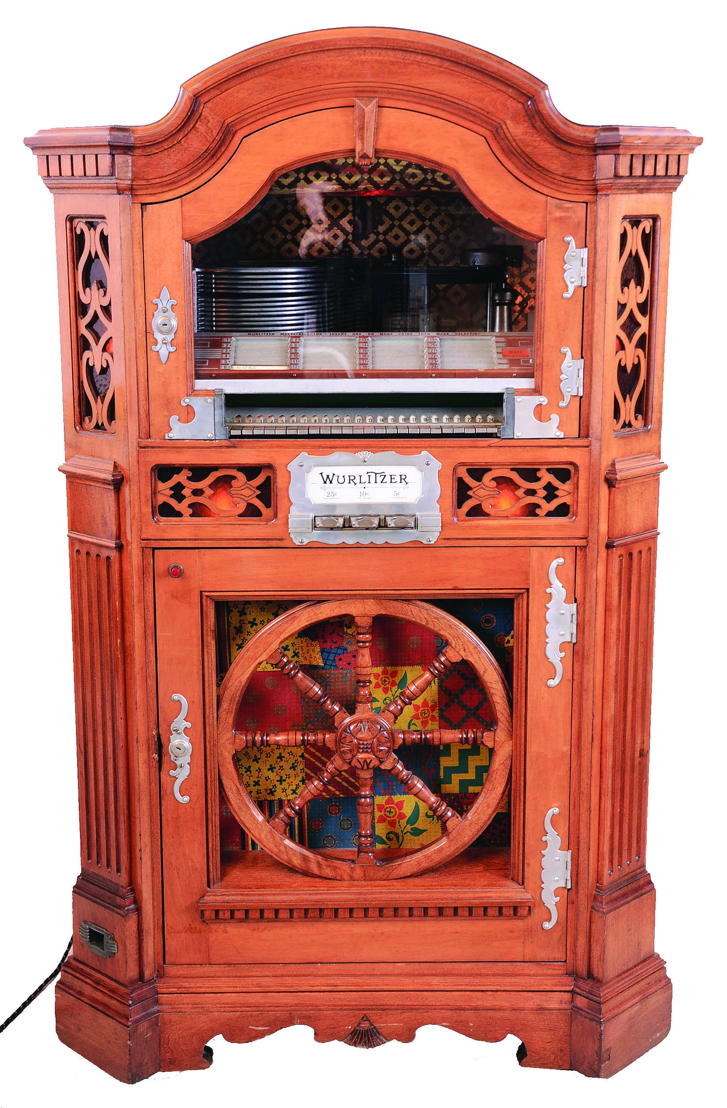 Rudolph Wurlitzer Co., North Tonawanda, NY. Model 780 was the only Wurlitzer juke box in a maple wooden cabinet which looked like a piece of furniture. The lower case features a wooden "Wagon Wheel" with a decorative quilt pattern behind it. This machine holds twelve 78 rpm records with 24 selections. Service manual included. — Antique Clocks Price Guide