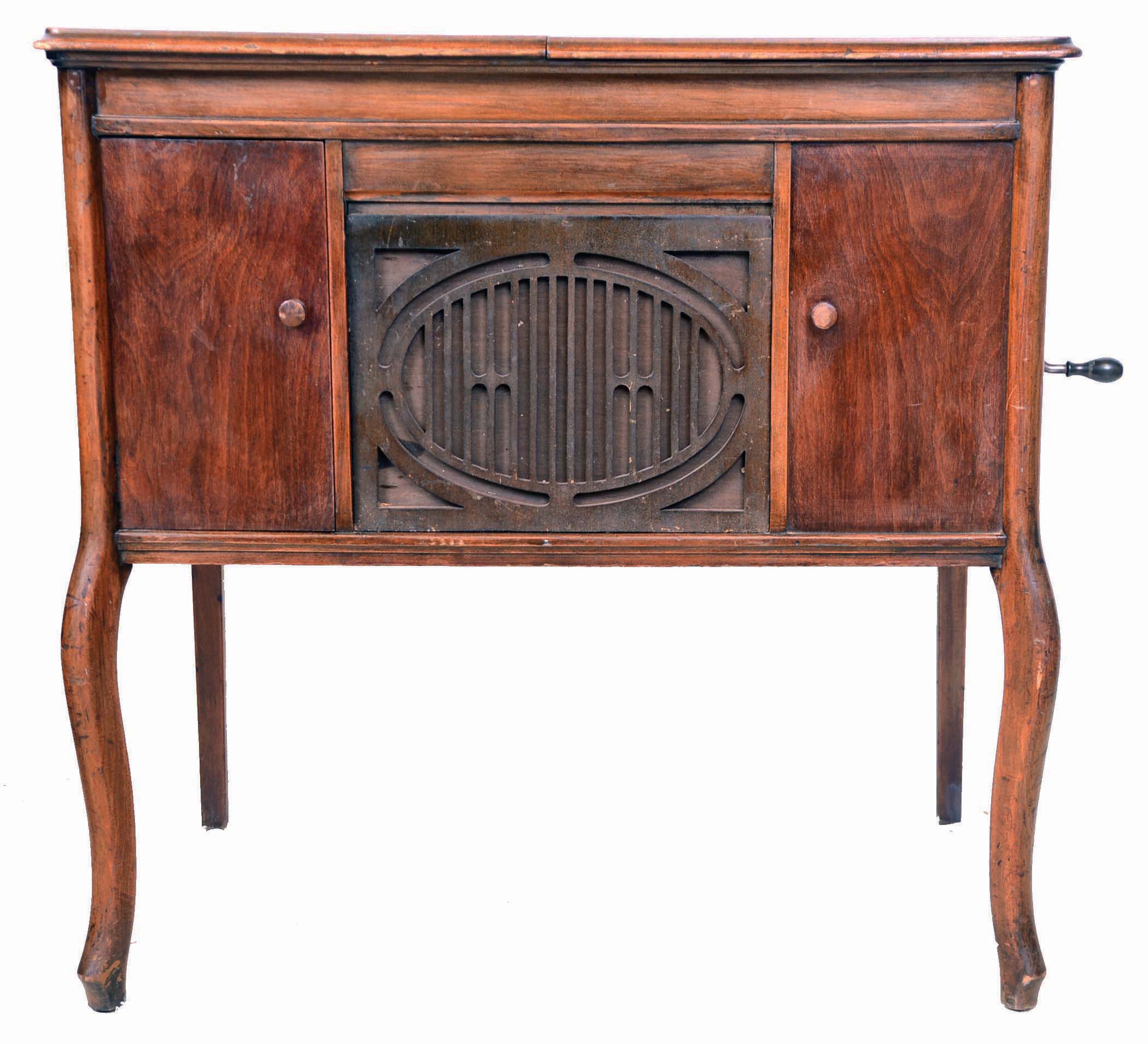 Brunswick Balke Collender Co., Chicago, IL. "Model 20" phonograph in walnut "low boy"-style case, serial #284662. Flat top case with record storage compartment left of decorative horn grill (right side is a dummy): This machine has an adjustable reproducer which plays regular 78 rpm discs and Pathe' discs. Interior has Brunswick decal and another with the name "Irvin Zuelke". — Antique Clocks Price Guide