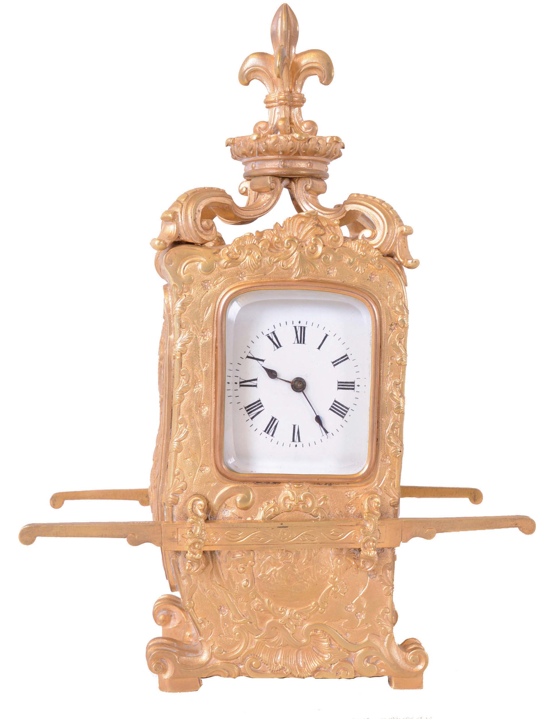France, for Maple & Co., London and Paris, hour repeating carriage clock in the form of a sedan chair, the gilt brass case with rococo style ornament with plaques featuring naughty putti, scrolls, and shells, case sides with carrying handles, the top with scrolled brackets supporting a fleur de lis finial, and with well executed portrait of a young woman, behind glass at right side, Roman numeral white enamel dial, 8 day time and strike movement with lever platform, counting the hours on a gong, and repeating on demand, movement signed — Antique Clocks Price Guide