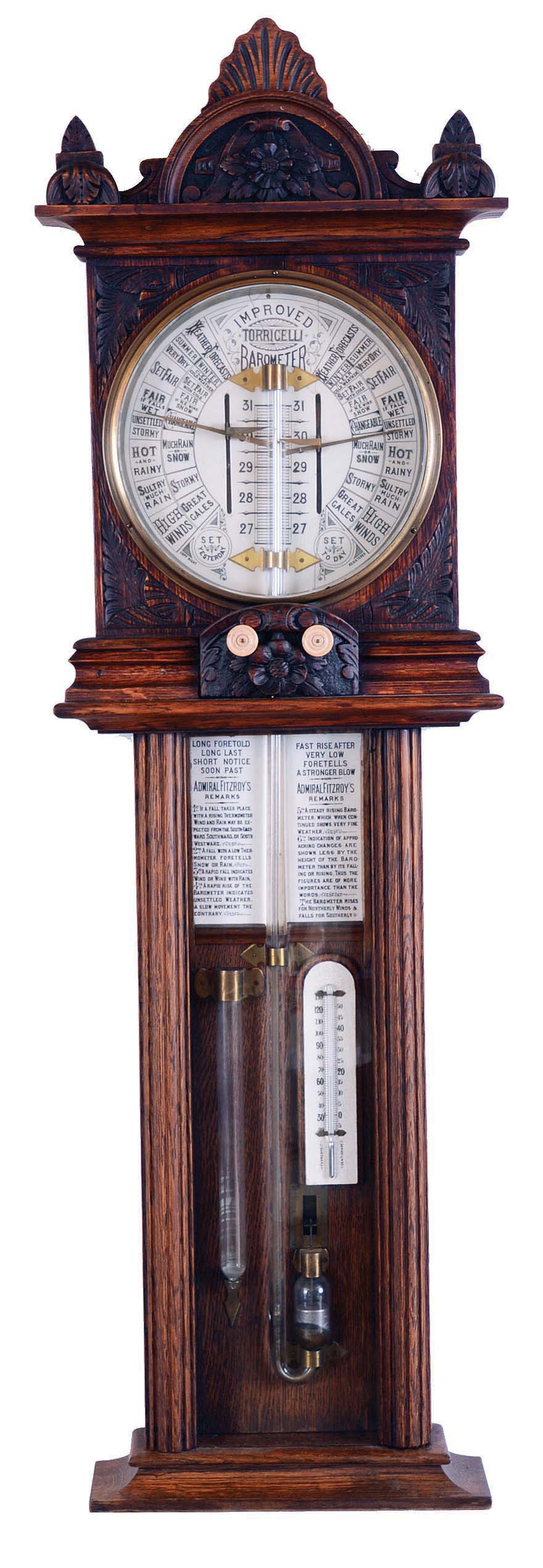 Admiral Fitzroy, "Improved Torricelli Barometer", English, in an oak case with carved top and carved bone stations for bone knobs for indicator hands. The enamel backing the barometer and above thermometer gives full details on use of the instrument and below that is a storm glass. — Antique Clocks Price Guide