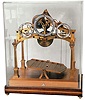 Congreve-style rolling ball clock, modern reproduction with "Dent" plate on the front, brass on wood base with Plexiglas cover, c2000