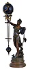 Swingers- 2 [Two] French, lot of small-medium ball style swing clocks, the movements contained within the brass spheres, suspended from the upraised arms of female statues. Larger figure is carrying a giant sea shell, the base signed "Reine des Flots, per Aug Moreau", smaller figure holds a large flower, unsigned.