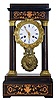 French, Empire style 4-column wooden cased portico clock of mahogany with contrasting satin wood inlay, and with grid pendulum with heavy cast brass bob, now polished.