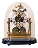 England, an unusual two train skeleton clock, 8 day time and strike movement recoil escapement, pierced brass plates and four turned pillars, supported on a heavy, brass portico base with turned columns finials, and feet, the spring barrels attached to the base, Gothic inspired Roman numeral silvered dial, blued steel hands, with oval base and dome, 20th century
